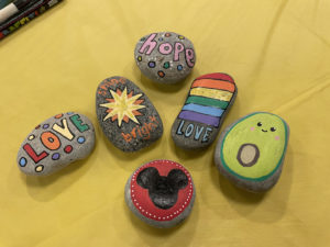Rocks painted with messages like "Love", "shine bright", and "hope".